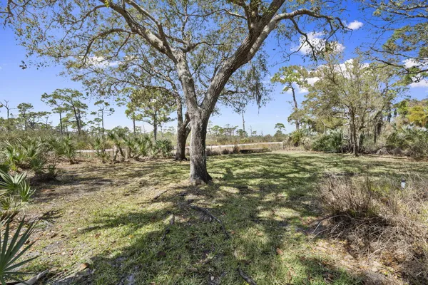 a living room with furniture a fireplace and a large window