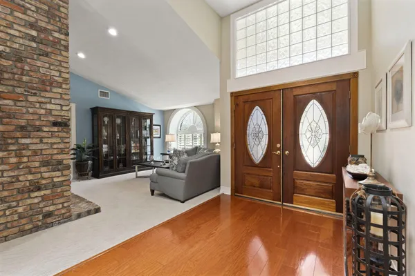 an aerial view of a house with a yard and trees