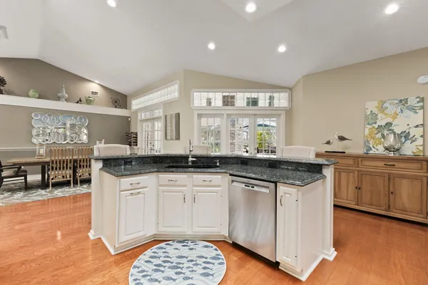 an aerial view of residential houses with outdoor space and trees