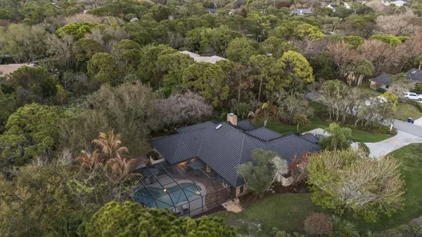 a view of a house with a yard and tree s