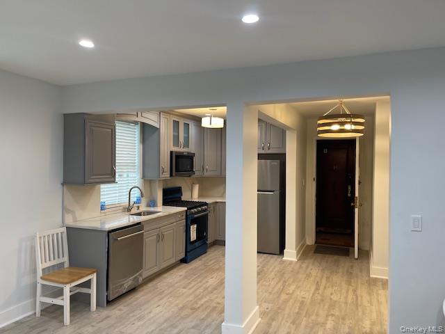 138-28 77th Avenue, Unit 64C Queens, NY 11367 - Photo 1 of 12 a room with a wooden floor and furniture