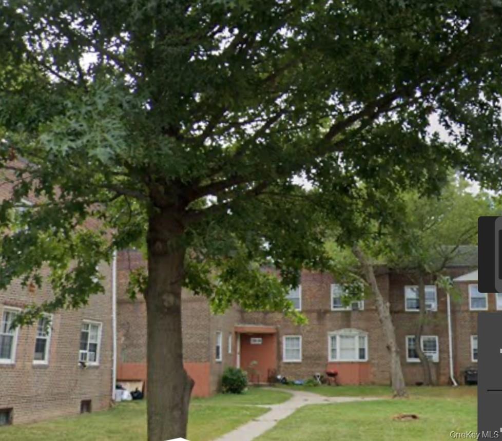 138-28 77th Avenue, Unit 64C Queens, NY 11367 - Photo 12 of 12 a front view of a house with a garden