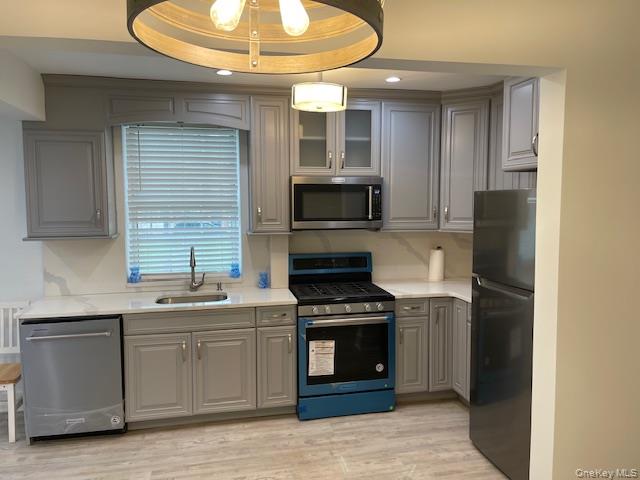 138-28 77th Avenue, Unit 64C Queens, NY 11367 - Photo 3 of 12 a kitchen with stainless steel appliances a stove a sink and a refrigerator