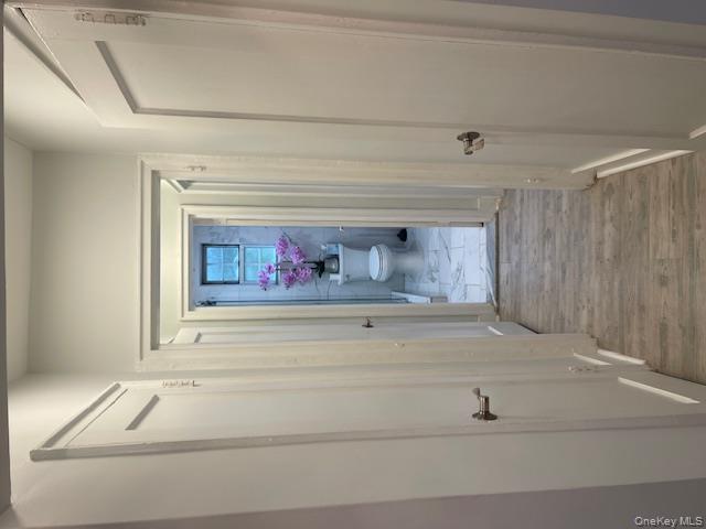 138-28 77th Avenue, Unit 64C Queens, NY 11367 - Photo 5 of 12 a view of a hallway view with wooden floor and closet