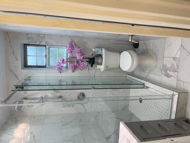 138-28 77th Avenue, Unit 64C Queens, NY 11367 - Photo 6 of 12 a bathroom with a toilet and a shower