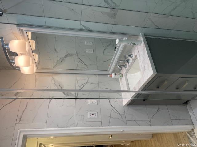 138-28 77th Avenue, Unit 64C Queens, NY 11367 - Photo 7 of 12 a bathroom with a sink shower and a mirror