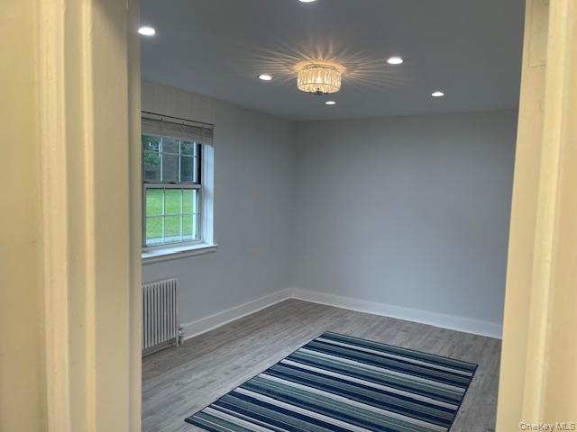 138-28 77th Avenue, Unit 64C Queens, NY 11367 - Photo 8 of 12 a view of a livingroom with wooden floor and window