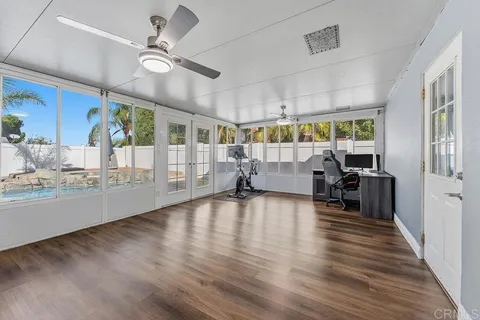 a very nice looking room with wooden floor and furniture