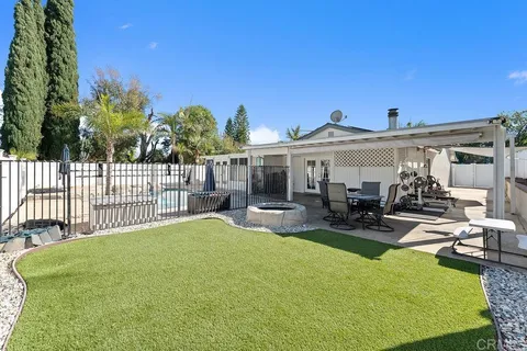 a view of a house with backyard porch and sitting area