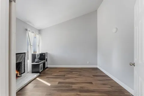a view of an empty room with a fireplace
