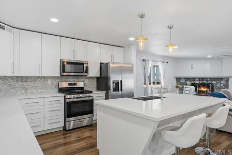 a kitchen with a sink appliances and cabinets
