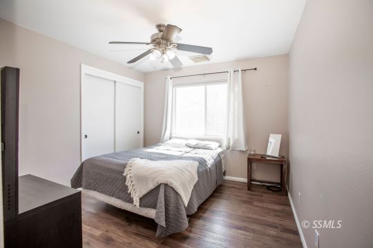 421 Christopher Court Ridgecrest, CA 93555 - Photo 21 of 50 a bedroom with a bed and a chandelier