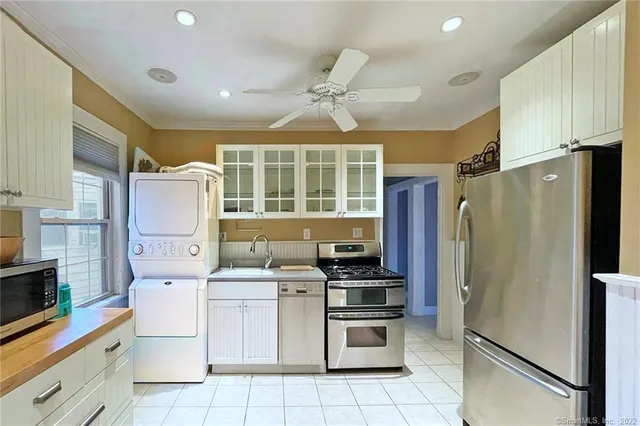 a kitchen with a refrigerator sink and stove top oven