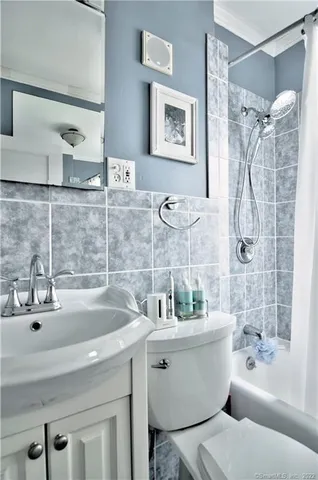 a bathroom with a sink mirror toilet and bathtub