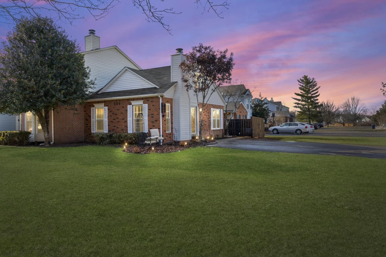 a front view of house with yard and green space