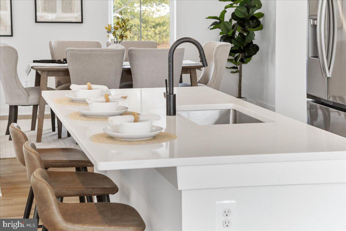 641 Swallowtail Drive Frederick, MD 21703 - Photo 13 of 52 a dining room with furniture and a potted plant