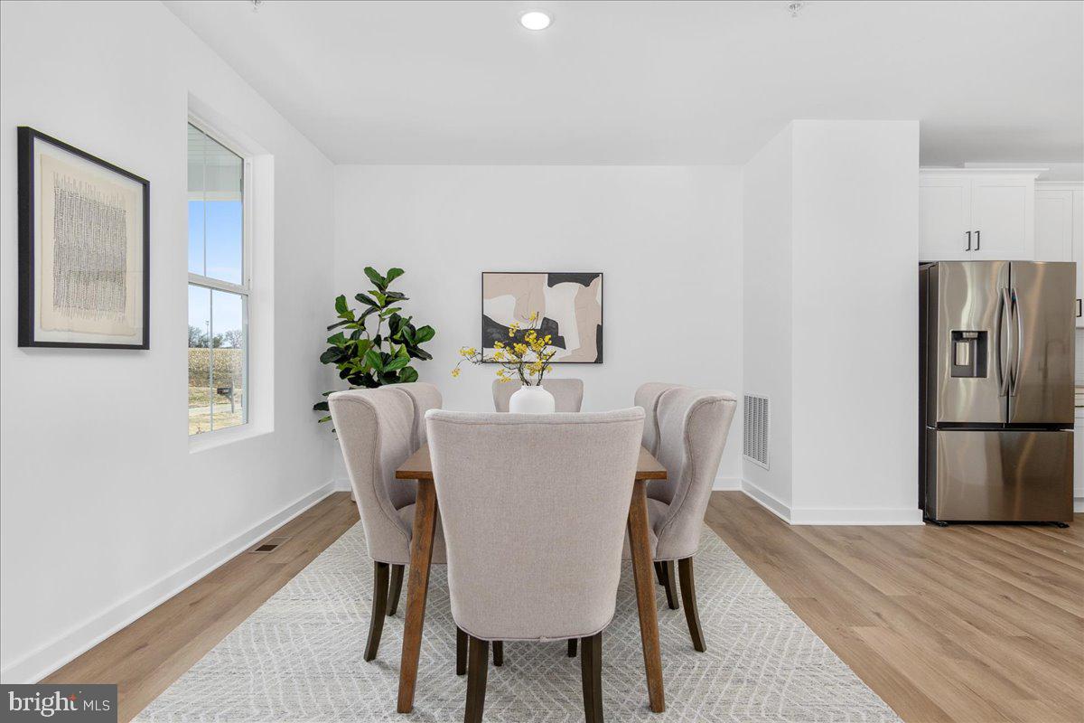 641 Swallowtail Drive Frederick, MD 21703 - Photo 20 of 52 a dining room with furniture and a kitchen view