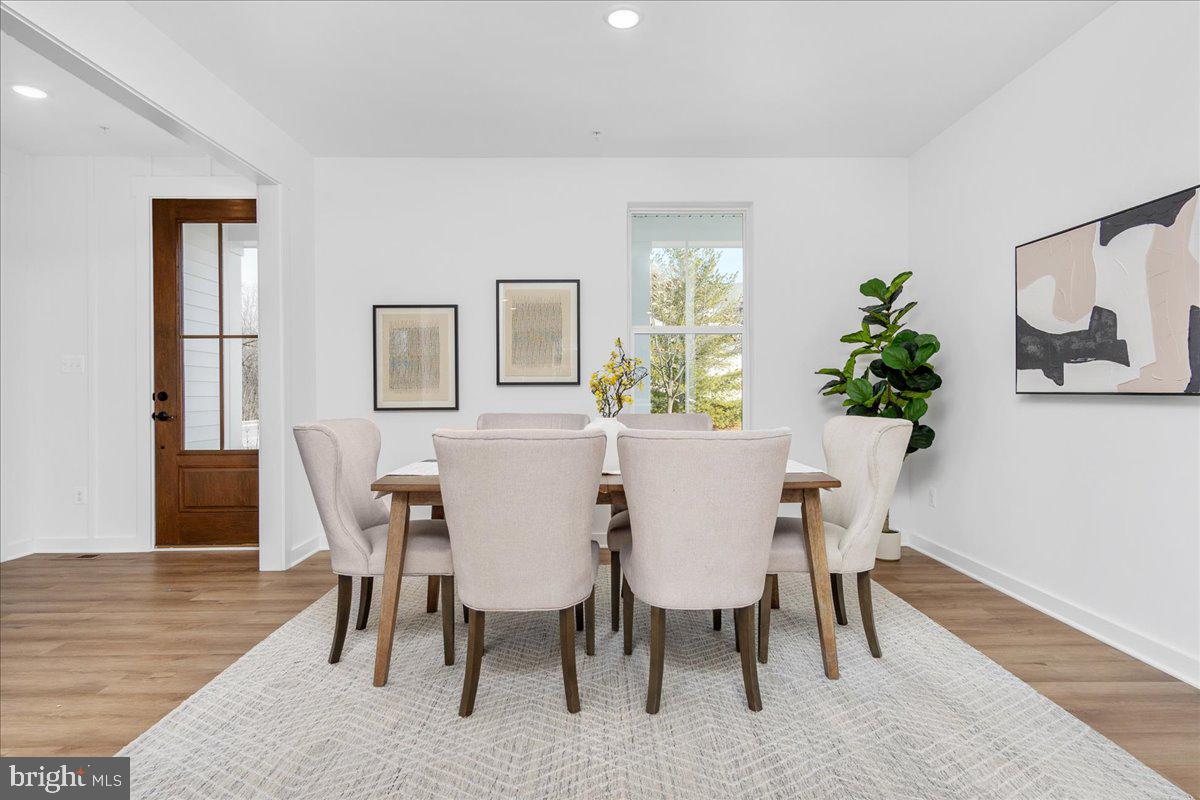 641 Swallowtail Drive Frederick, MD 21703 - Photo 21 of 52 a view of a dining room with furniture window and wooden floor