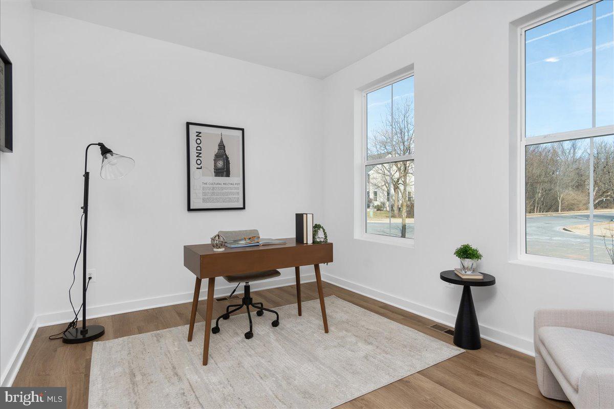 641 Swallowtail Drive Frederick, MD 21703 - Photo 22 of 52 a living room with furniture a window and a potted plant