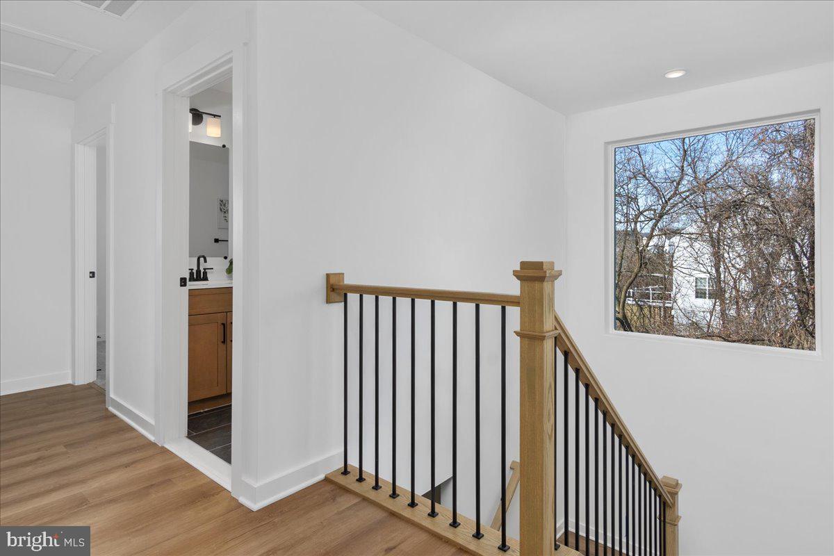 641 Swallowtail Drive Frederick, MD 21703 - Photo 26 of 52 a view of a hallway with wooden floor and stairs