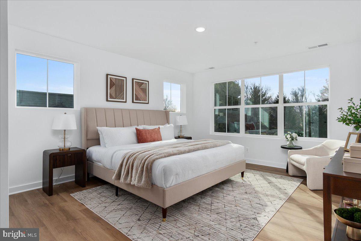 641 Swallowtail Drive Frederick, MD 21703 - Photo 27 of 52 a bedroom with a bed and wooden floor