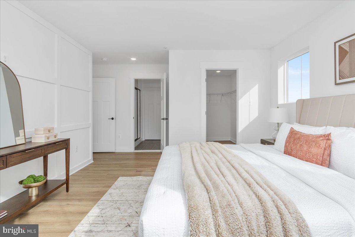 641 Swallowtail Drive Frederick, MD 21703 - Photo 28 of 52 a bedroom with a bed and a flat screen tv