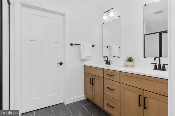 a bathroom with a glass shower door