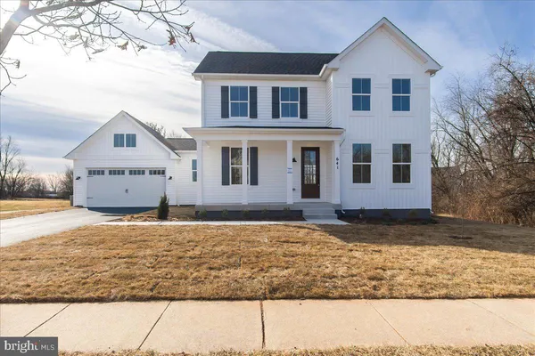 a house that has a tree in front of it