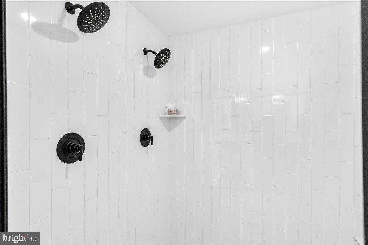 641 Swallowtail Drive Frederick, MD 21703 - Photo 31 of 52 a bathroom with a shower and a window