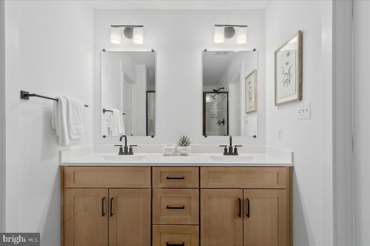 641 Swallowtail Drive Frederick, MD 21703 - Photo 33 of 52 a bathroom with a double vanity sink and mirror