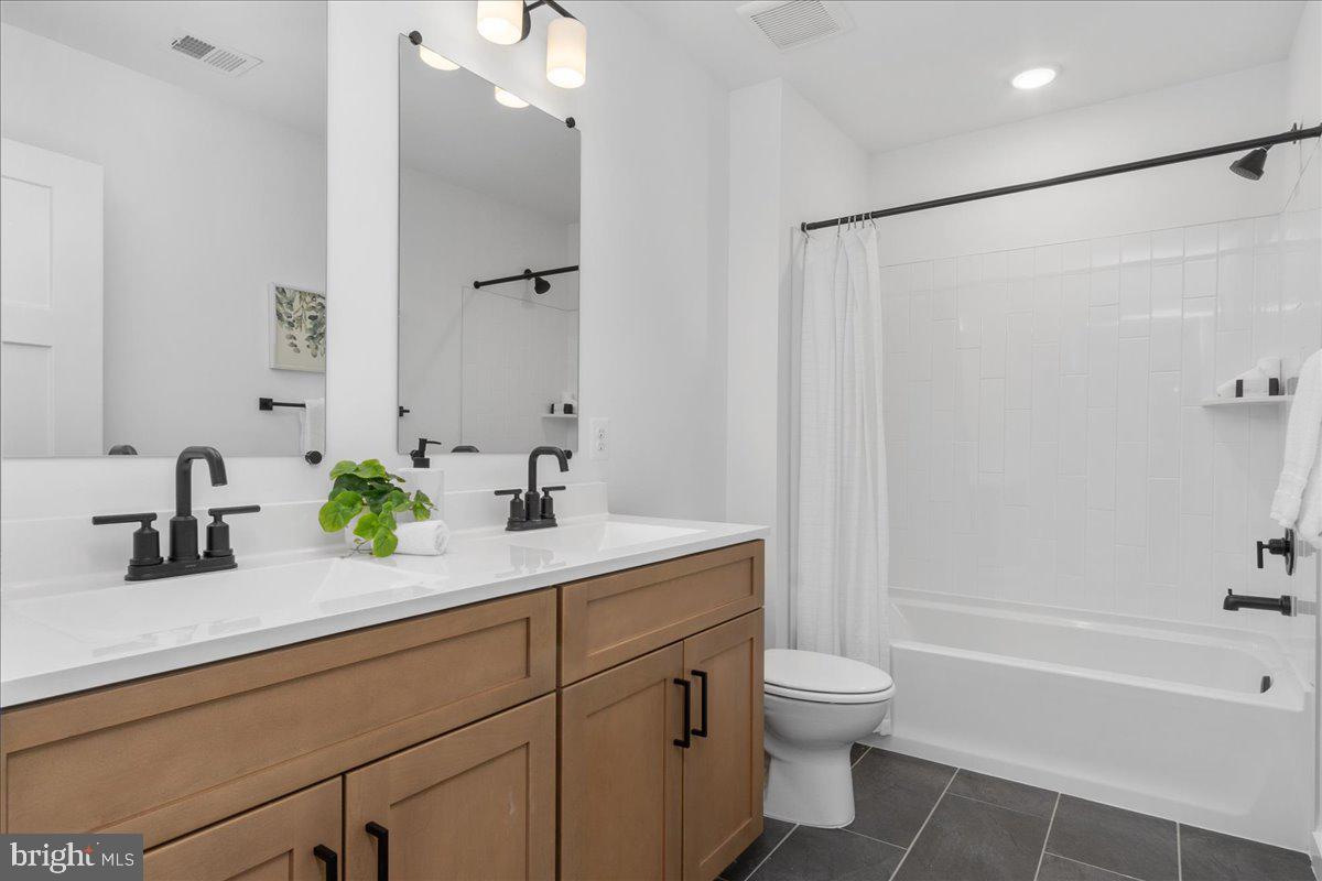 641 Swallowtail Drive Frederick, MD 21703 - Photo 38 of 52 a bathroom with a granite countertop sink a toilet and a bathtub