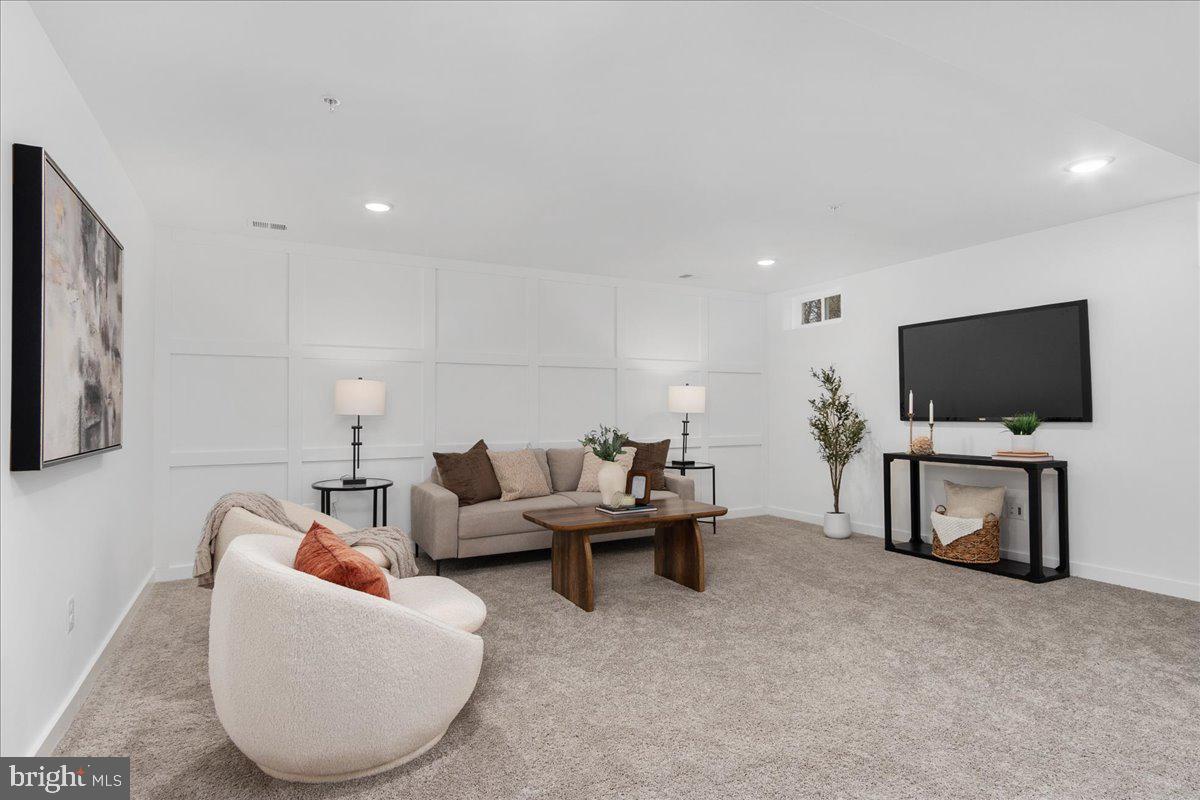 641 Swallowtail Drive Frederick, MD 21703 - Photo 40 of 52 a living room with furniture and a flat screen tv