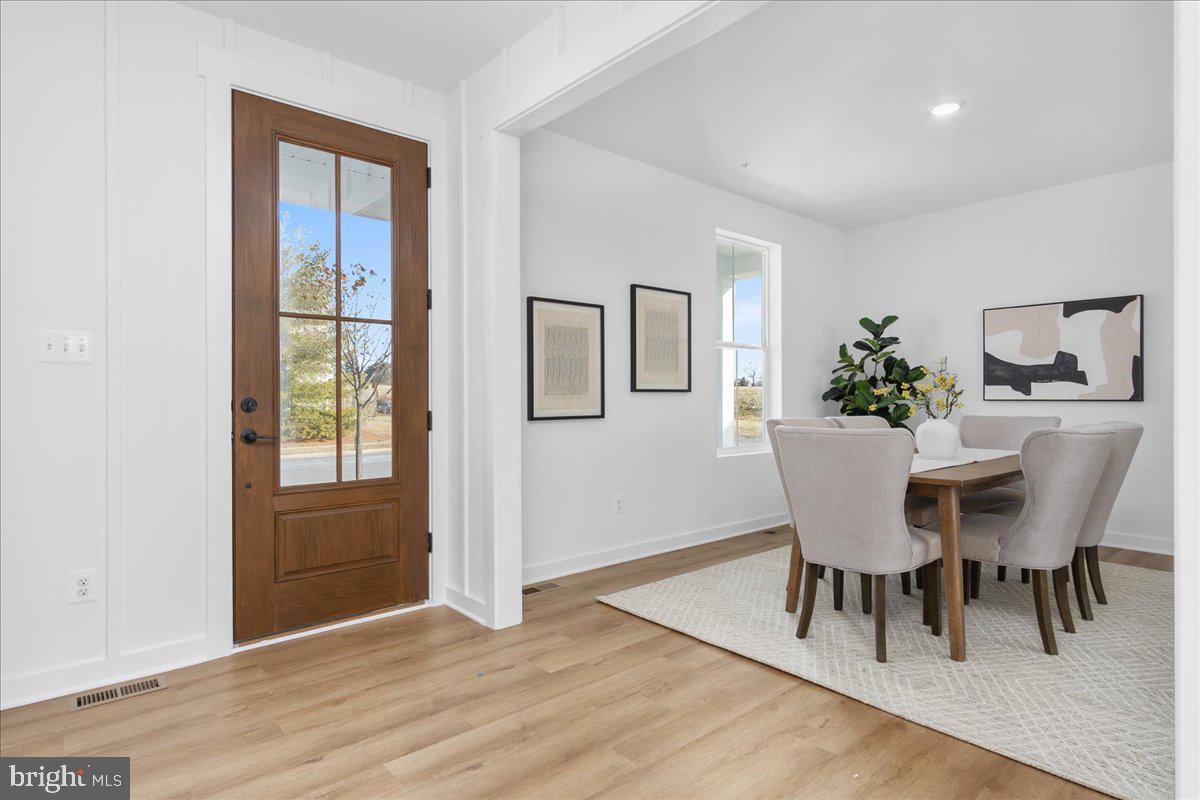 641 Swallowtail Drive Frederick, MD 21703 - Photo 4 of 52 a view of a dining room with furniture window and wooden floor