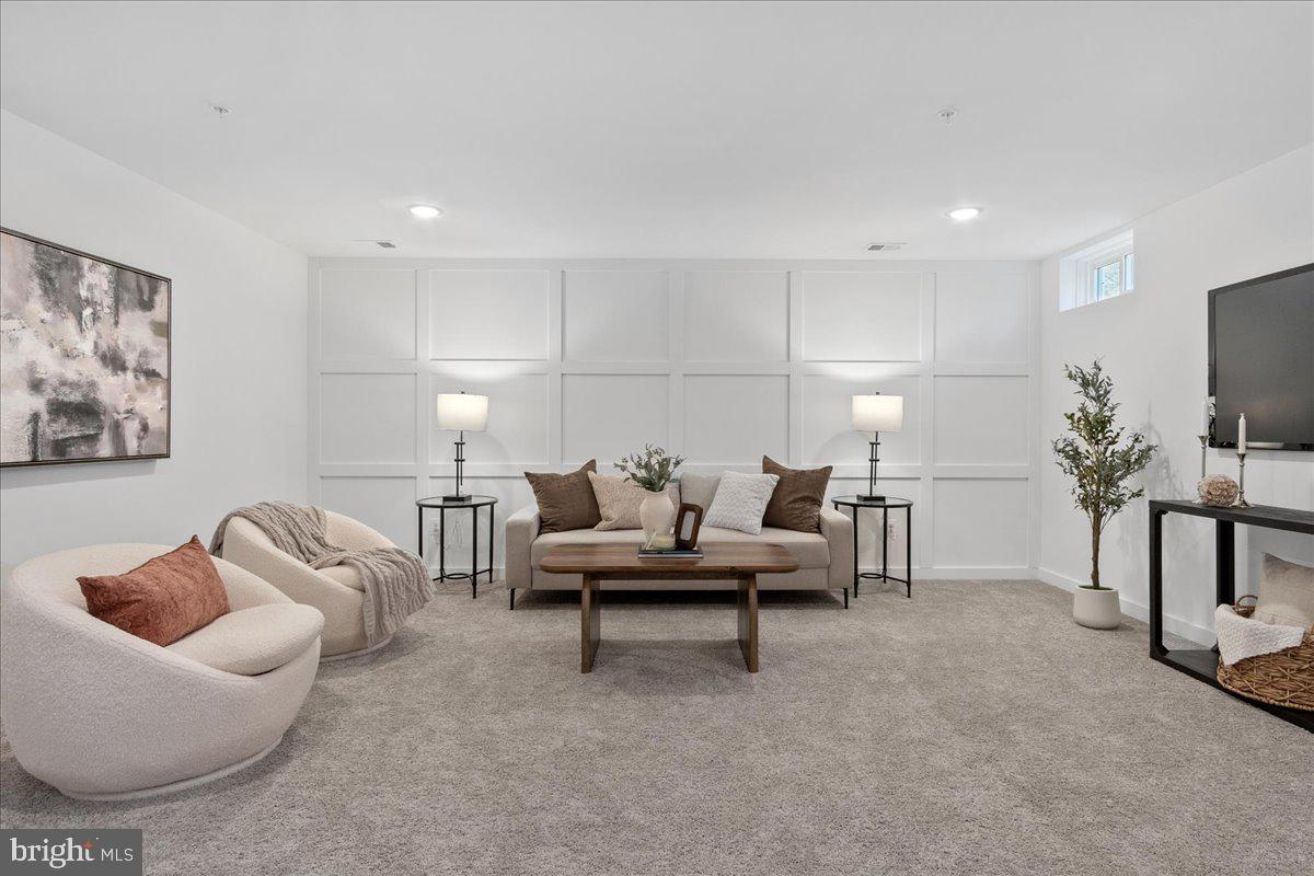 641 Swallowtail Drive Frederick, MD 21703 - Photo 41 of 52 a living room with furniture and a flat screen tv