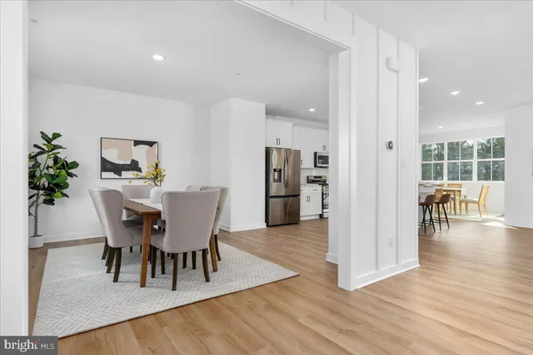 a dining room with furniture and wooden floor