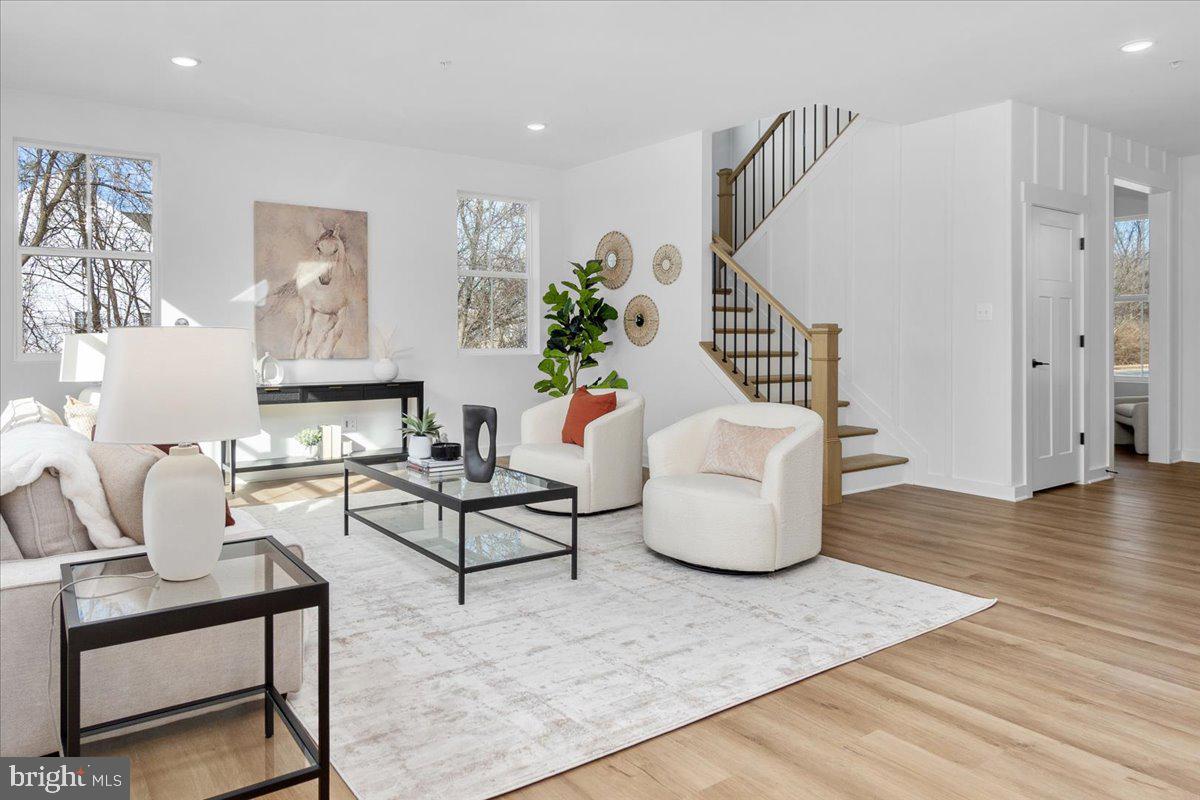 641 Swallowtail Drive Frederick, MD 21703 - Photo 6 of 52 a living room with furniture and a wooden floor