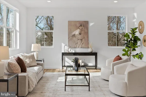 a living room with furniture a rug and a painting on the wall
