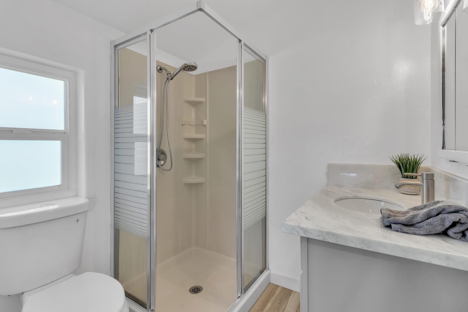 3053 Boeing Road Cameron Park, CA 95682 - Photo 59 of 67 a bathroom with a granite countertop sink a toilet and shower