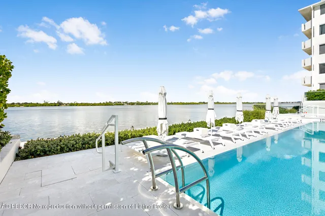 a view of a lake with couches chairs and city view