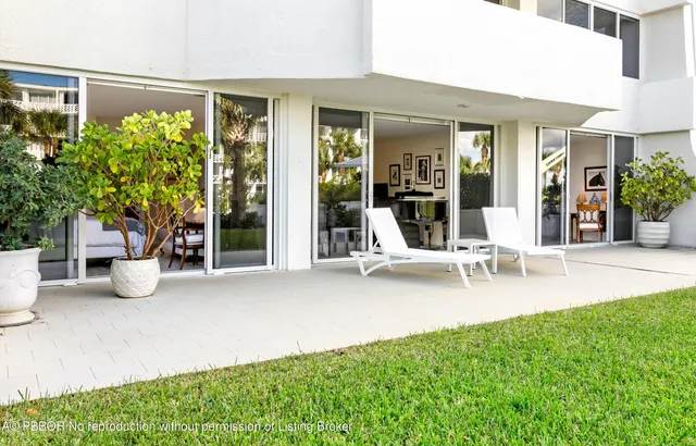 a view of a house with backyard porch and sitting area
