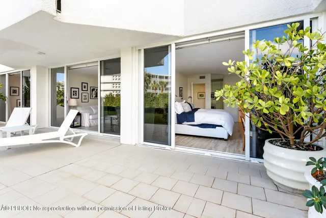 a bedroom with a bed and a potted plant
