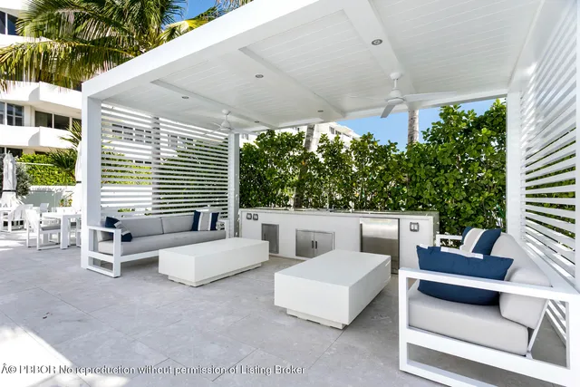 a living room with furniture a table and kitchen view