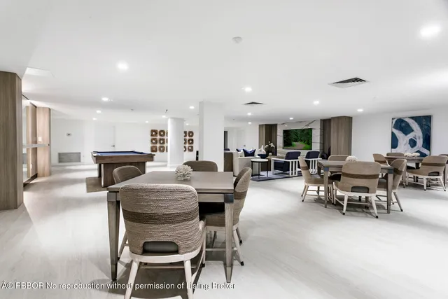 a living room with furniture a wooden floor and potted plant