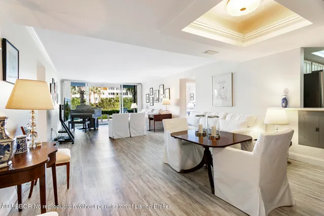 a living room with fireplace furniture and a chandelier