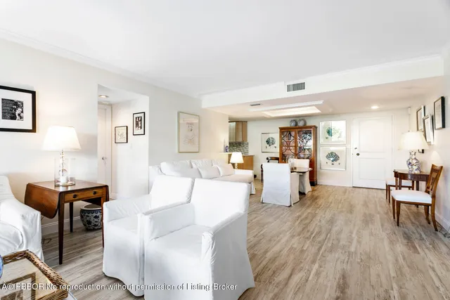 a living room with fireplace furniture and a wooden floor