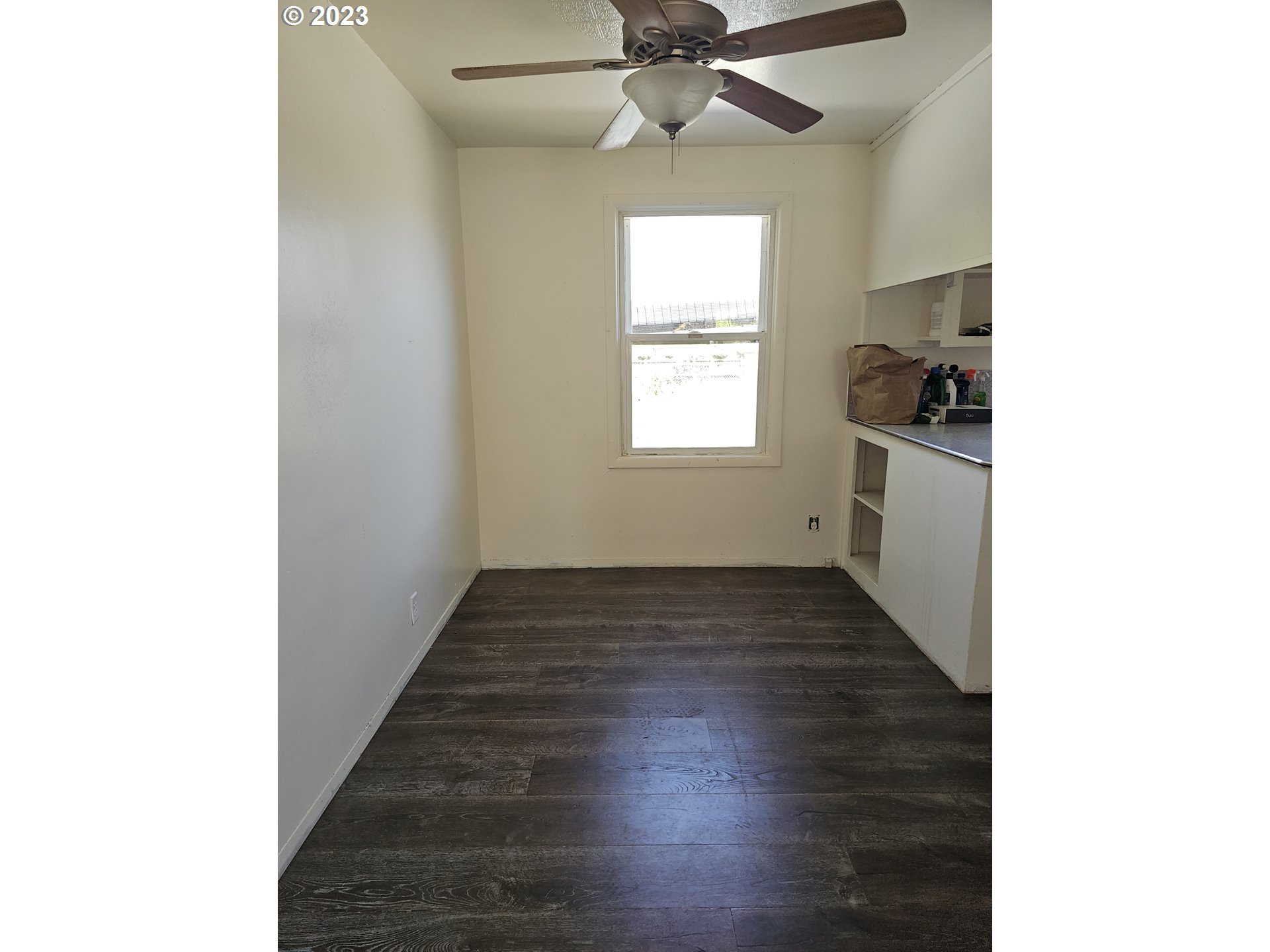 1278 M Street Springfield, OR 97477 - Photo 5 of 13 a view of an empty room with wooden floor and a window