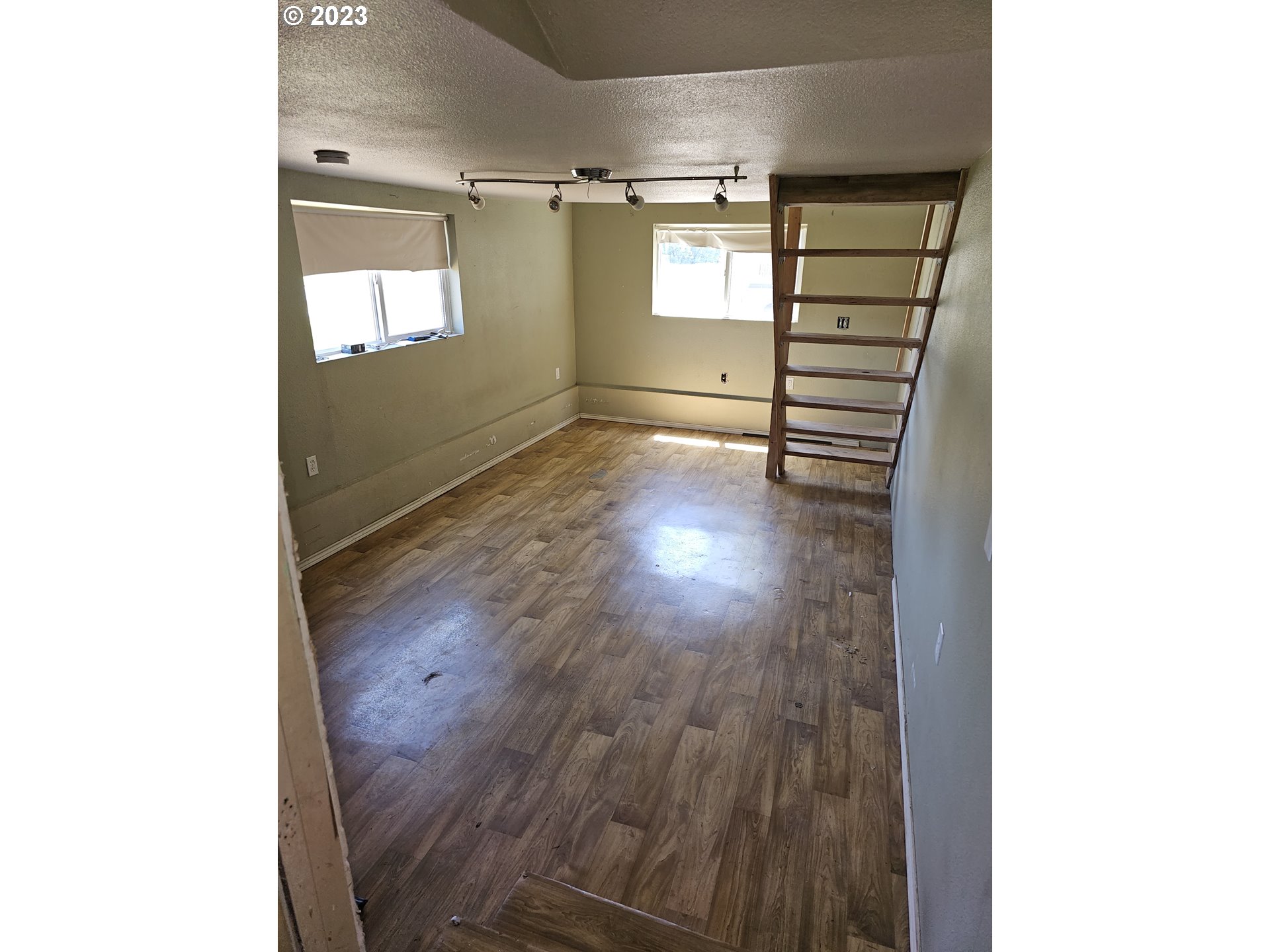 1278 M Street Springfield, OR 97477 - Photo 9 of 13 a view of an empty room with a window and wooden floor