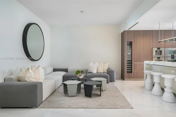 a living room with furniture and a mirror