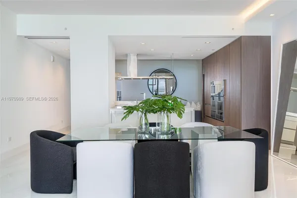 a dining room with furniture and potted plant