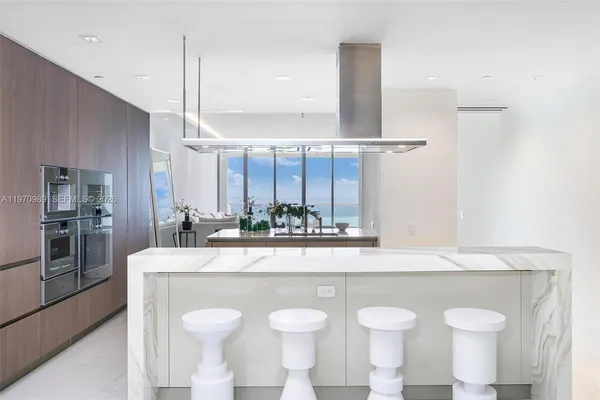 a kitchen with stainless steel appliances a sink and a refrigerator